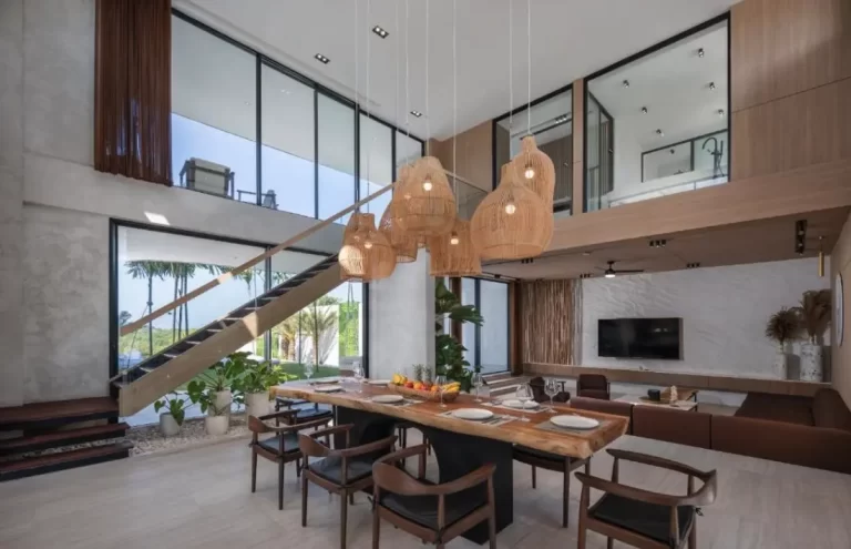 Earthy-chic Ungasan villa dining room with floor-to-ceiling windows and tropical views