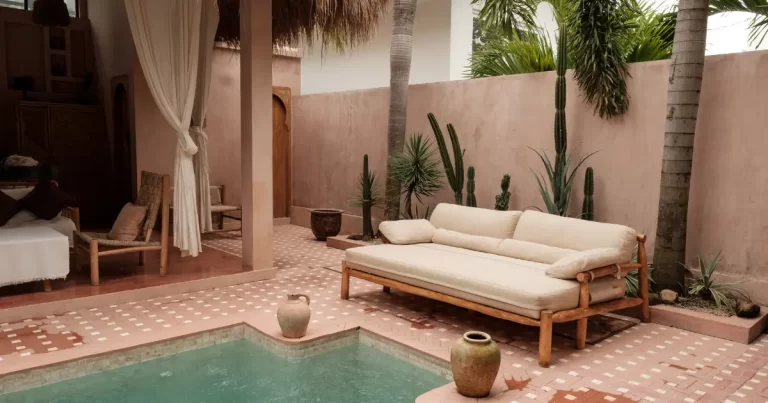 Beautiful Bali villa courtyard featuring a pool, terracotta tiles, natural elements, and organic fabrics, showcasing the top design trends of 2025.