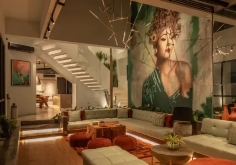 Sunken velvet lounge with lush plants, statement art, and modern Balinese decor at Mandala Oasis
