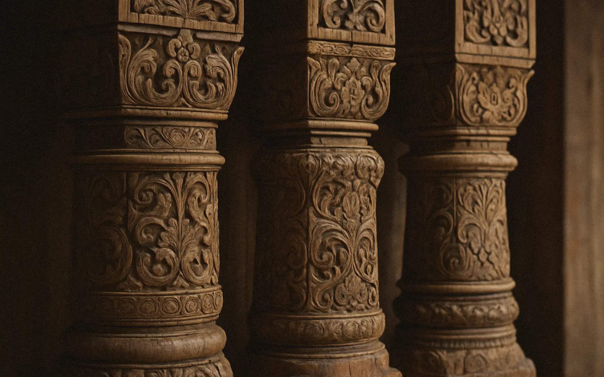 Ornately carved teakwood columns from an authentic joglo.