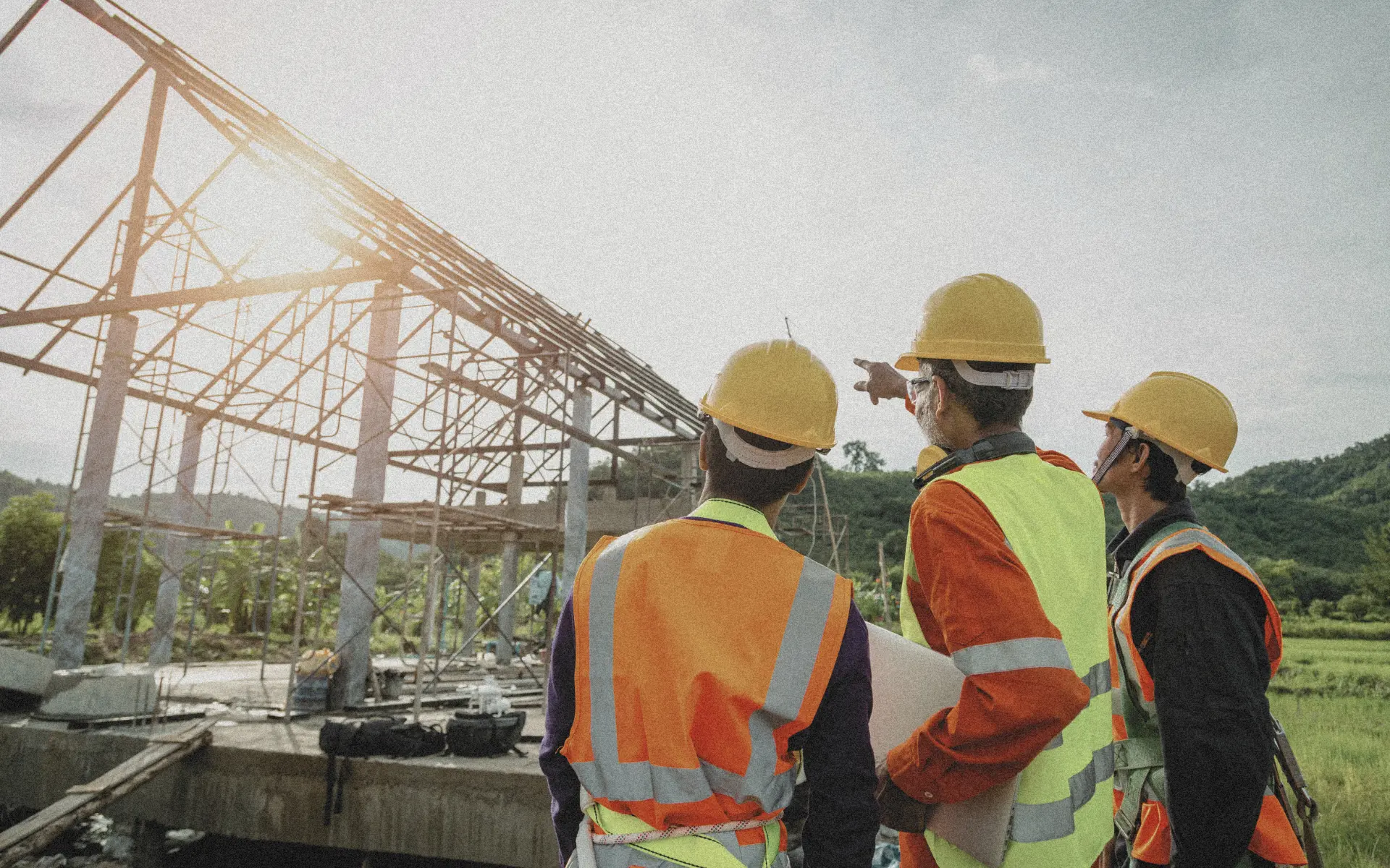 Construction workers pointing toward a building site in rural Bali.