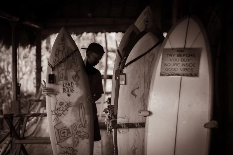 Staff stacking surfboards outside Drifter Surf shop in Uluwatu