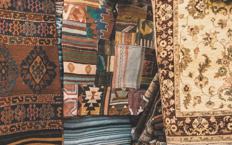 Close-up of stacked and hanging kilim and Persian rugs in Bali