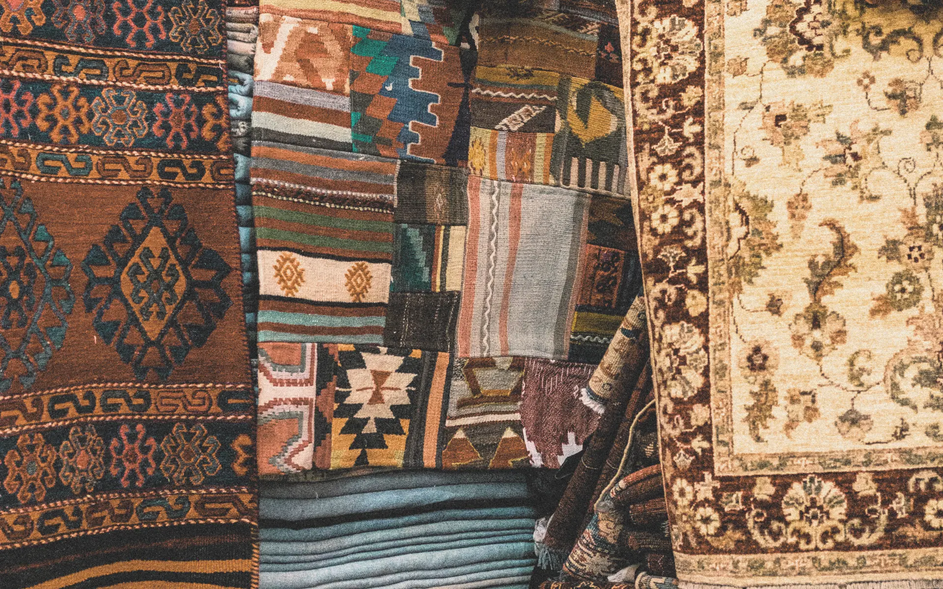 Close-up of stacked and hanging kilim and Persian rugs in Bali