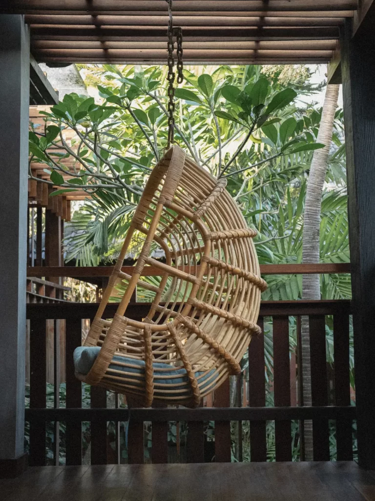 Pool overlooking jungle with a small bale corner: “Adiwana Hotel pool with jungle backdrop and private bale, Ubud.