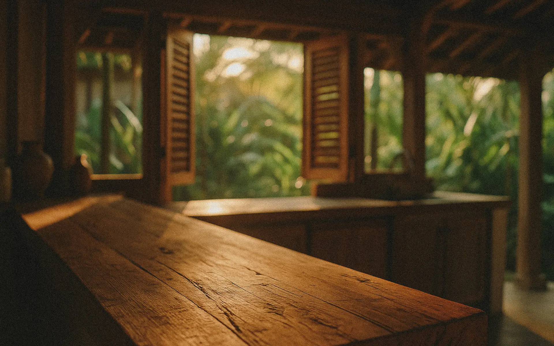 Sustainable Bali villa design with reclaimed teak countertop and tropical greenery.
