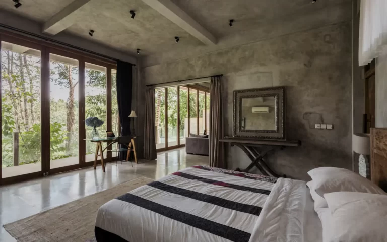 Master bedroom at RiverView Gardens overlooking jungle and Petanu River through floor-to-ceiling windows