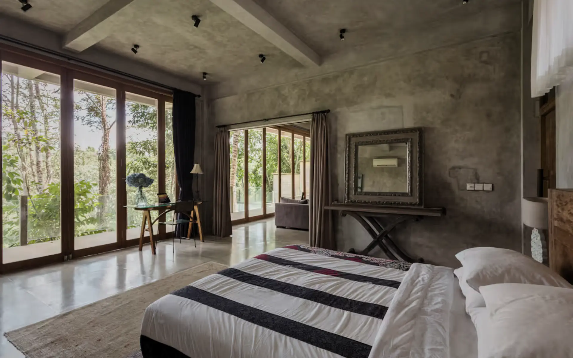 Master bedroom at RiverView Gardens overlooking jungle and Petanu River through floor-to-ceiling windows