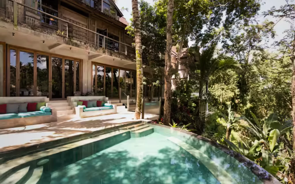 Infinity pool at RiverView Gardens overlooking jungle with main villa in background