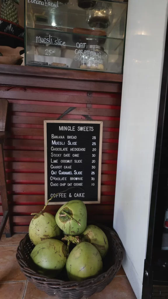 Fresh coconuts and chalkboard menu with sweets at Mingle Café Ubud