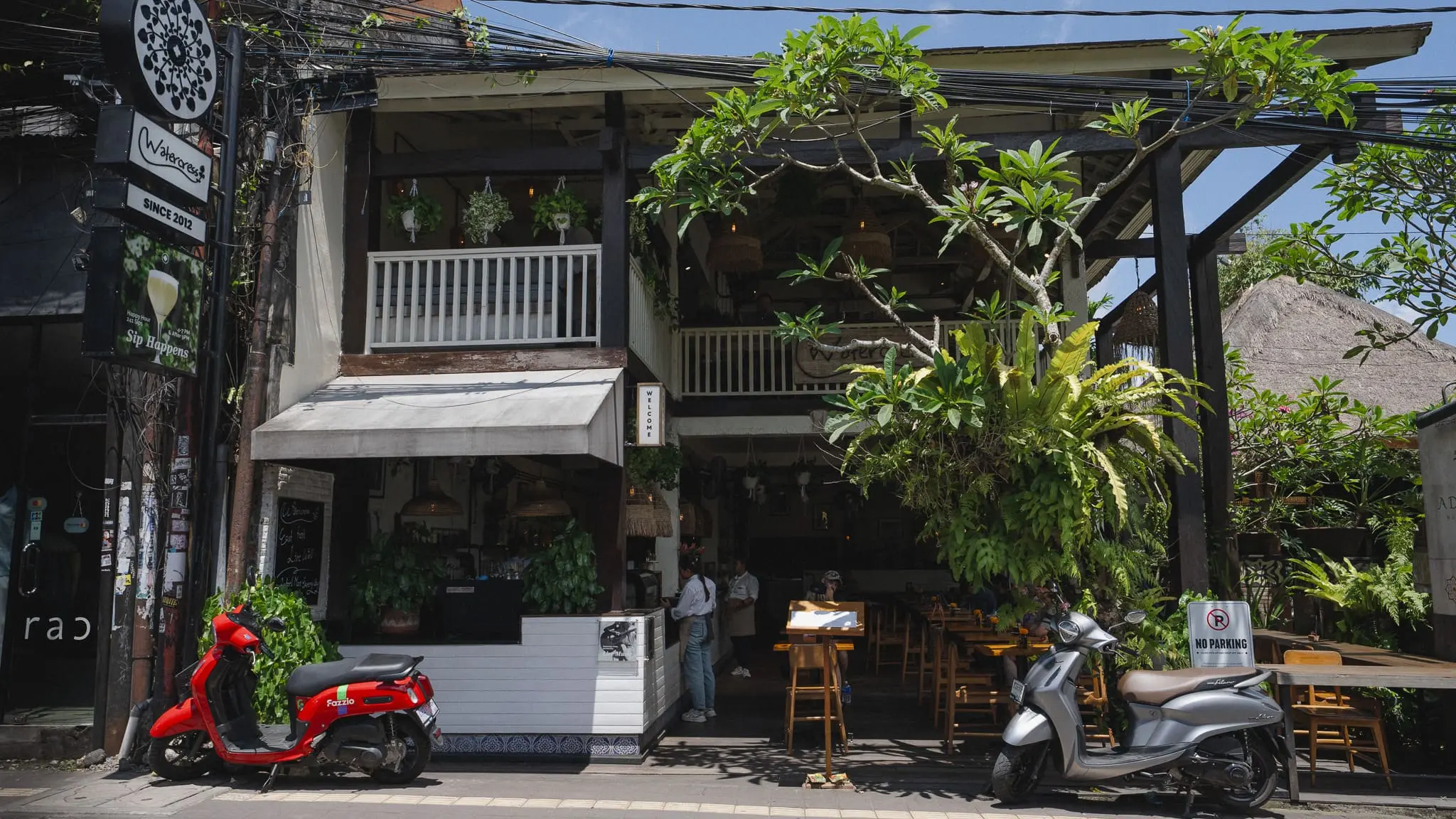 Watercress Ubud white two‑story restaurant facade with sign and motorbikes parked outside