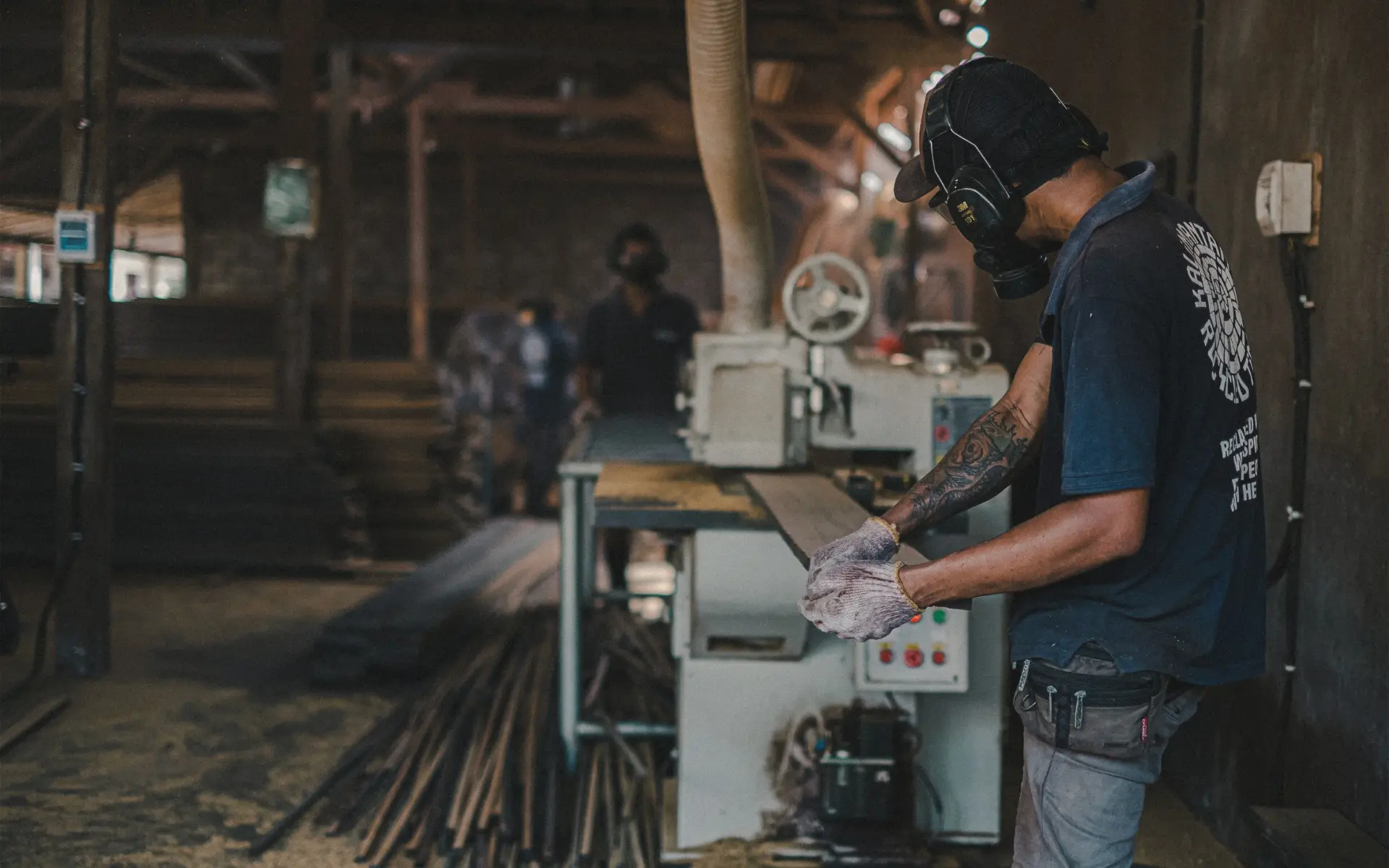 Kaltimber team member processing reclaimed ulin ironwood in the workshop
