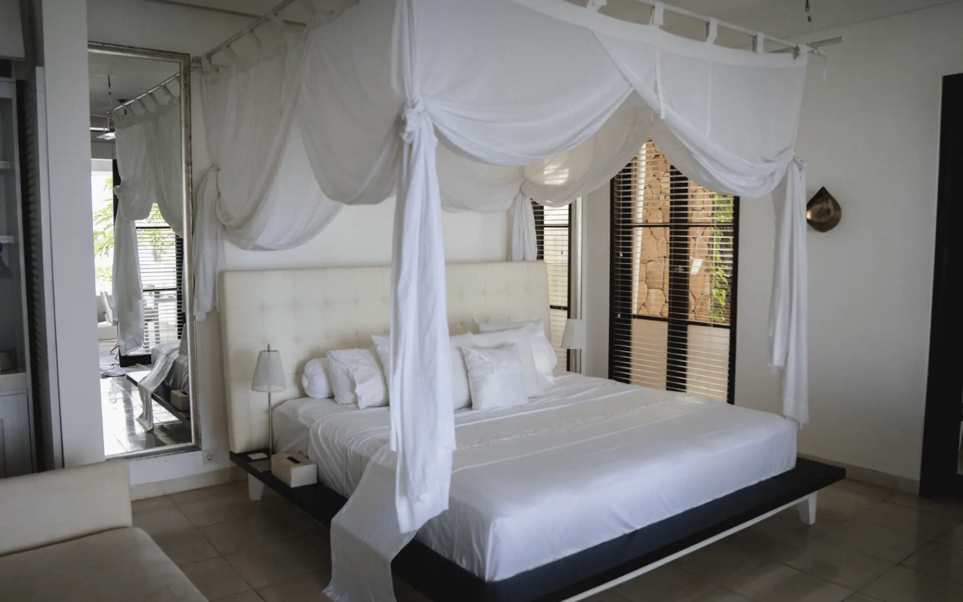 Minimal white canopy bedroom inside Shunyata Villas in East Bali