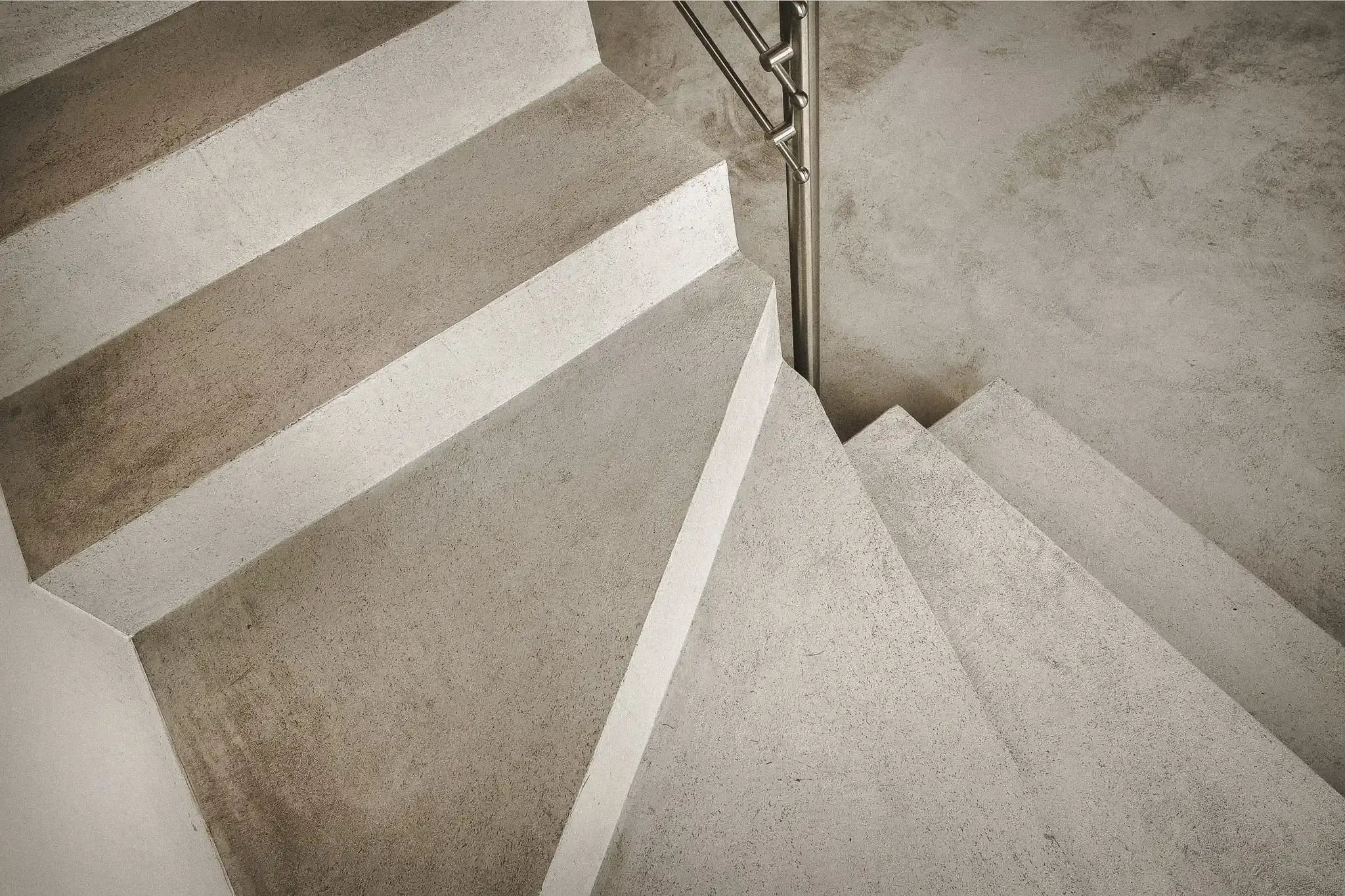 Minimalist microcement staircase inside a contemporary tropical home.