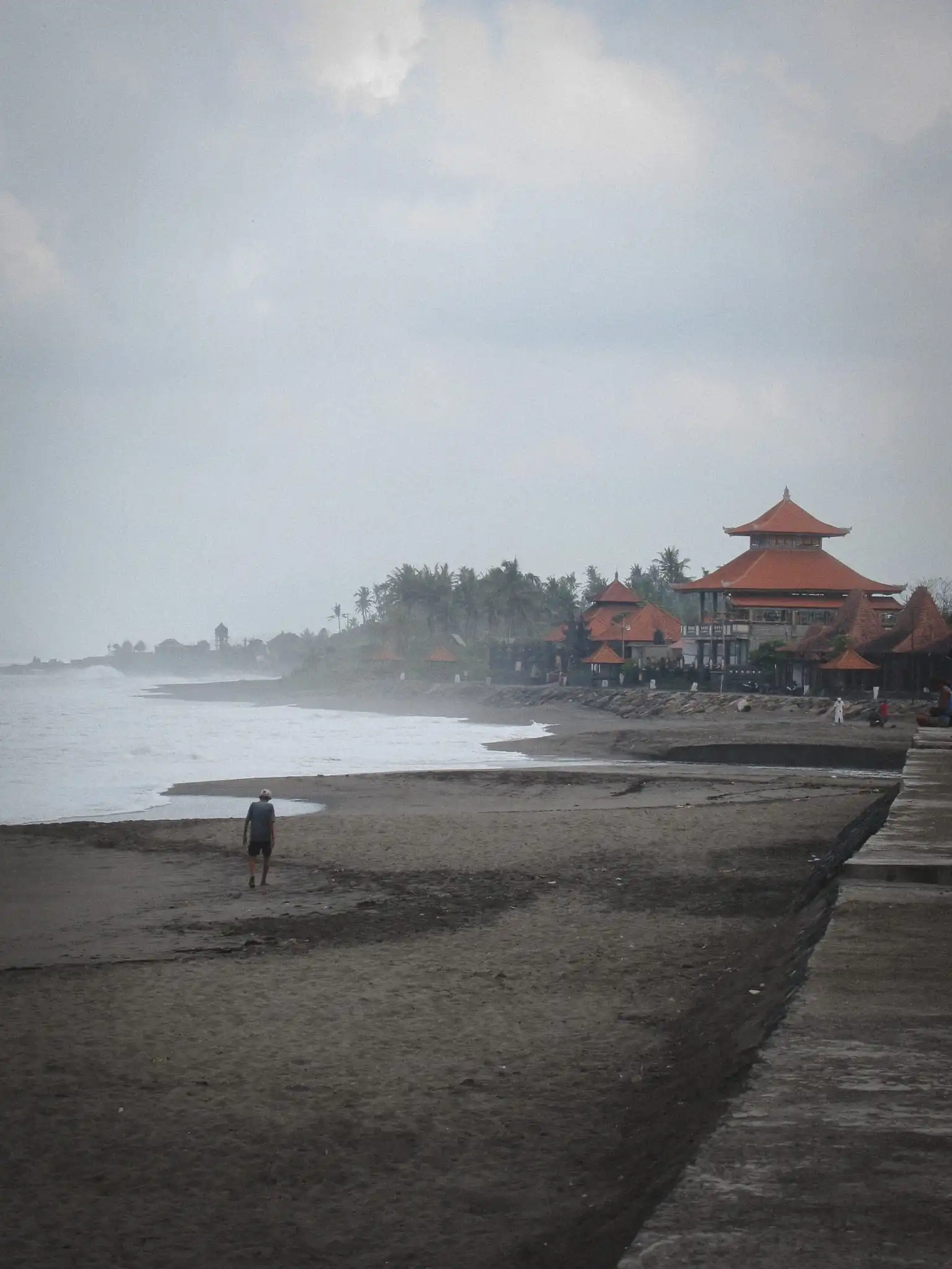 Palm trees and buildings overlooking the Bali coastline